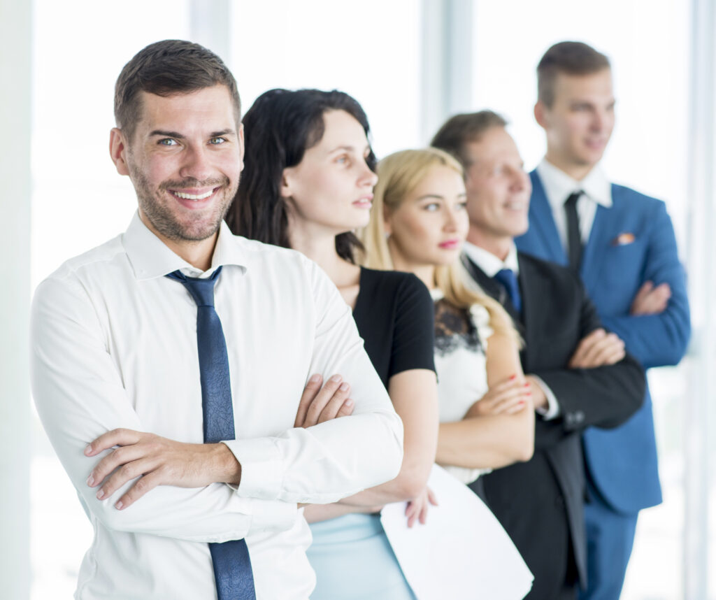 portrait-happy-manager-with-his-employees-standing-row